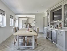 a dining room and kitchen area with wood flooring