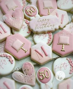 pink and white decorated cookies with the number 50 on them