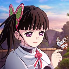 a girl holding a butterfly in her hand