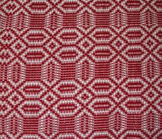 a red and white fabric with an intricate design on the front, in very close up