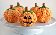 rice krispy treats decorated to look like jack o lantern pumpkins on a plate