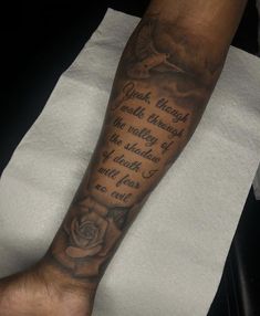 a man with a rose tattoo on his arm