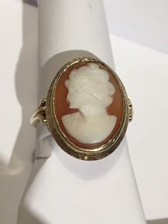 "This is a beautiful condition vintage 14kt yellow gold genuine hand carved shell cameo. Slightly worn but profile and features are very well defined in this classic face. Beautiful beaded bezel holds this cameo in place and the setting and fine detail on shank of ring are stunning. Cameo measures approximately 1/2\" wide and 5/8th \" long. Size 6. Shank is sturdy and this ring will last for generations to come. A true timeless classic. Inside is hallmarked(unreadable) and 14kt is stamped in it. Vintage 14k Gold Cameo Rings, Classic Oval Cameo Rings, Antique Cameo Signet Ring For Weddings, Cameo 14k Gold Rings For Collectors, Gold Cameo Signet Ring Collectible, Collectible 14k Gold Cameo Rings, Gold Signet Ring With Cameo Collectible, 14k Gold Cameo Rings For Collectors, Vintage Yellow Gold Cameo Rings