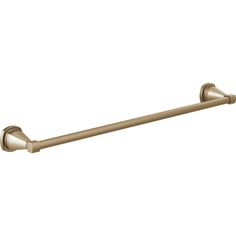 an antique brass towel bar on a white background