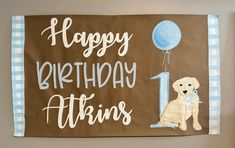 a happy birthday sign with a dog and balloon