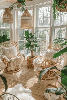 wicker chairs and plants in a sun room with large windows, rugs and potted plants