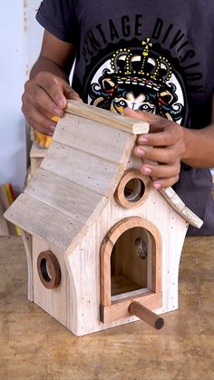 a man is making a birdhouse out of wood