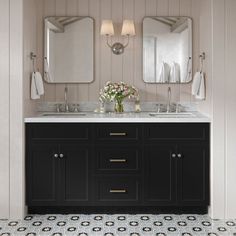 a bathroom with two sinks and mirrors on the wall