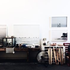 a room filled with lots of different types of art on the wall next to a table