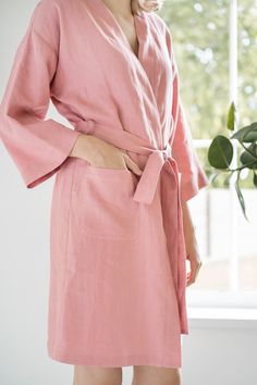 "A natural linen bathrobe will become Your best friend on a lazy morning, a cozy evening or a trip. With the \"LinenRain\" bathrobe, You will feel how it clings to Your skin and gently envelops You. This type of bathrobe can be used as a bridal or a bridesmaid bathrobe, as a high quality linen will look extremely luxurious and refined. DETAILS: <> Made from OEKO-TEX® certified 100 % European linen; <> Color in the picture: Salmon blush; <> Robe length 97 cm / 38.\" (inch). < Muslin Clothing, Kate Middleton Coat, Linen Robes, Bridesmaid Bathrobe, Womens Robe, Linen Bathrobe, Linen Robe, Personalized Robe, Lazy Morning