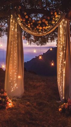 an outdoor wedding set up with string lights