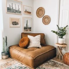 a living room filled with furniture and pictures on the wall