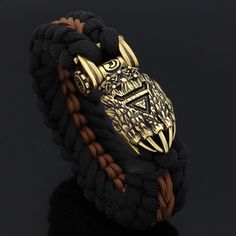 The Preferred Disguise Of Gods During visits to the human world, Odin as well as Thor often takes on the appearance of bear as a disguise. Therefore, bears tend to be looked upon as the forefathers of man in ancient times. Bears symbolize wisdom, strength, and healing that bring balance to seen and the unseen world. This bracelet features a bear paw accent with a Runic inscription at its front face. This type of bracelet is a Paracord bracelet which are also known as survival bracelets and is co Adjustable Black Viking Bracelet, Black Viking Jewelry For Outdoor, Black Viking Style Jewelry For Outdoor, Black Viking Style Outdoor Jewelry, Adjustable Black Bracelet For Collectible, Adjustable Black Bracelet For Collectors, Norse People, Viking Cosplay, Paracord Braids