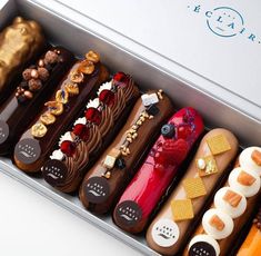 a box filled with lots of different types of cakes