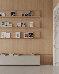 there are many books on the shelves in this room with marble flooring and walls