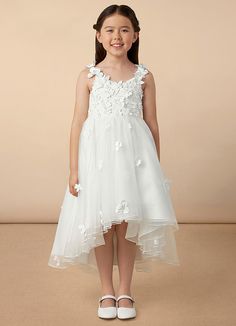 Your flower girl will look pretty like a princess in Ceres, our floral tulle Ball-Gown dress. She features a lace bodice and straps adorned with 3D flowers, a frilly tulle high-low skirt, and a beautiful matte satin bow at the back. Sleeveless Tulle First Communion Dress With Floral Applique, Sleeveless Tulle Dress With Floral Applique For First Communion, Spring Confirmation Gown Made Of Tulle, Spring Confirmation Gown In Tulle, Spring Tulle Gown For Confirmation, Tulle First Communion Dress With Floral Applique, Sleeveless Tulle Gown For Confirmation, Ivory Ball Gown, White Ball Gowns