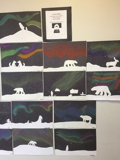 several polar bear paintings are displayed on the wall