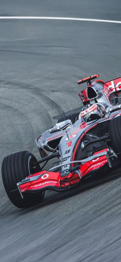 a red and white race car driving on a track