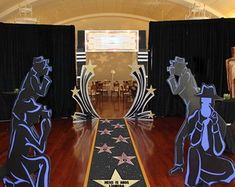 an image of a stage set up for a star ceremony with statues on the floor