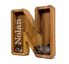 a wooden letter that has some coins in it