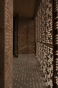 shadows cast on the wall and floor in an empty room with wooden slatted walls