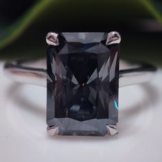 a fancy ring with an emerald cut stone