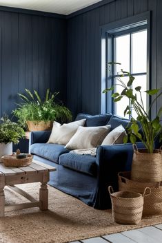 a living room filled with furniture and lots of potted plants on top of it