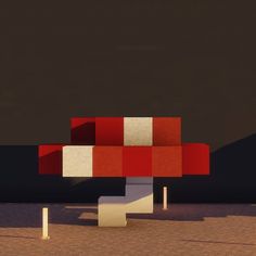 a red and white object sitting on top of a cement ground next to two poles