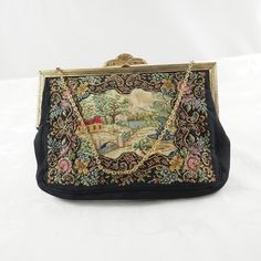 Lovely little vintage petit point figural evening bag. The front with a  black ground with a border of scrolls, butterflies, roses, forget-me-not and violets, surrounding a white crepe de Chine insert embroidered with a landscape with a bridge, fountain, weeping willow and a house with mountains in the distance, no figures! The reverse and gusset in black only. With a cord piping. With a brass frame with Art Deco tilt-clasp with pierced leaves and scrolls. With a ornate oval chain-link handle. W Antique Embroidered Evening Bags, Vintage Embroidered Evening Bags, Vintage Evening Bag In Tapestry Material, Vintage Tapestry Bag For Evening, Victorian Style Black Bag For Vintage Events, Black Victorian Bag For Vintage Events, Vintage Embroidered Clutch Evening Bag, Embroidered Rectangular Bag For Vintage Events, Embroidered Rectangular Bags For Vintage Events