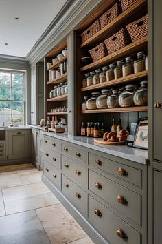 a kitchen filled with lots of counter top space next to a large open window on the wall