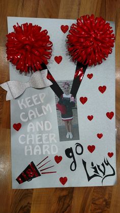 a poster with red pom - poms on it that says keep calm and cheer hard