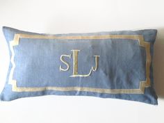 a blue and gold pillow with the word slu on it