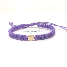 This bracelet is made of purple waterproof rope and a gold plated heart charm. Casual Gold Waxed Cord Jewelry, Trendy Purple Braided Bracelet For Gift, Trendy Purple Braided Bracelet Gift, Gold Heart Friendship Bracelets With Sliding Knot, Everyday Gold Friendship Bracelets With Heart Charm, Gold Waxed Cord Friendship Bracelets, Gold Waxed Cord Friendship Bracelet, Purple Adjustable Heart Bracelet For Valentine's Day, Adjustable Purple Heart Bracelet For Valentine's Day