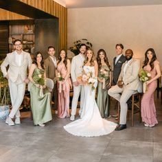 a group of people standing next to each other in front of a table with flowers