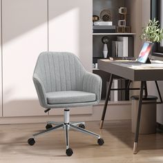 a gray office chair sitting in front of a desk with a laptop computer on it