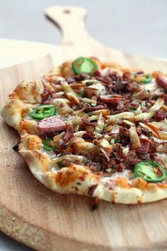 a pizza sitting on top of a wooden cutting board