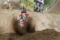 a person riding a dirt bike in the mud