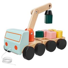 a wooden toy truck with colorful blocks on the front and sides, connected to a cord