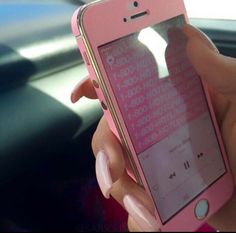 a person holding an iphone in their hand with the screen partially covered by pink stickers