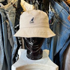 Kangol Washed Bucket Hat- Khaki Casual Beige Bucket Hat With Flat Brim, Vintage Outdoor Hats For Spring, Casual Beige Bucket Hat, Casual Beige Bucket Hat With Curved Brim, Vintage Bucket Hat For Outdoor Spring Use, Vintage Spring Sun Hat For Outdoor, Casual Cream Bucket Hat For Outdoor, Casual Beige Flat Brim Bucket Hat, Vintage Bucket Hat For Spring Outdoor