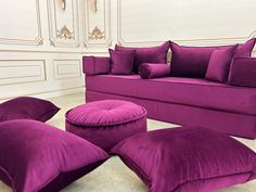 a purple couch and ottoman in a room