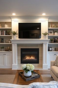 a living room filled with furniture and a flat screen tv mounted above a fire place