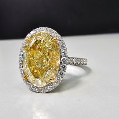 6.16 carat center Fancy Light Yellow Diamond Oval Cut VS1 Clarity GIA Certified Diamond Excellent + Very Good cutting Surrounded by 0.69 Carats of White Diamonds Set in Platinum & 18k Handmade in NYC Ready to Ship Oval Canary Yellow Diamond Ring, Oval Yellow Diamond Ring, 12 Carat Diamond Ring, Oval Yellow Diamond Engagement Ring, Canary Diamond Engagement Ring, Yellow Sapphire Engagement Ring, Dig Jewelry, Yellow Sapphire Ring Engagement, Yellow Gemstone Ring