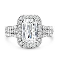 an emerald - cut diamond ring with pave set shoulders and halos surrounding the band