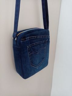 a denim purse hanging on the wall