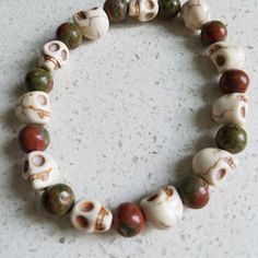 Unakite And White Howlite Skulls Bracelet. Perfect For Stacking! Handmade. Stretch Cord. Unisex. One Size. Ideally Fits Wrist Size 6.5" To 7.5". **For The Perfect Fit, Please Comment With Your Wrist Measurement For More Designs, Check Out 87rockwooddesign On Etsy! *Veteran Owned And Operated *A Portion Of Sales Will Be Donated To A Veteran Charity Power Bracelet, Red Beaded Bracelet, Caged Necklace, Lava Bead Bracelet, Skull Pendant Necklace, Hematite Bracelet, Skull Bracelet, White Howlite, 5 To 7