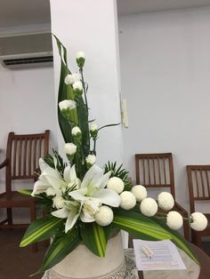 a vase filled with white flowers on top of a table