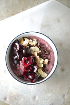 a bowl filled with fruit and nuts on top of a table