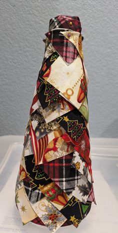 a multicolored tie is stacked on top of each other in the shape of a christmas tree