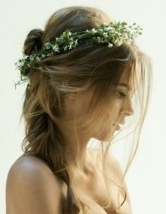 a woman with long hair wearing a flower crown